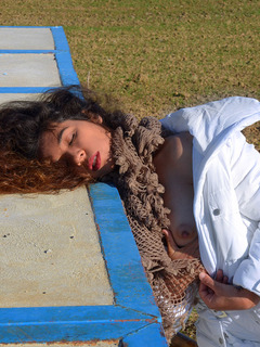 Curvacious hairy black-haired peeing in urban place