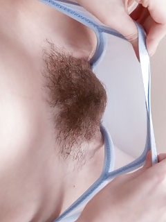 Lola Gatsby Sits In Her Blue Top And Black Miniskirt On Her Leather Couch