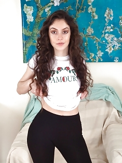 Anastasia Is Posing By Her Armchair In Her White Top And Black Tights