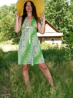 Julie Enjoys The Feel Of The Warm Sun On Her Hairy Pussy. See Her Have Some Alone Fun In Her Big Hat And Hot Dress Out In The Long Grass.
